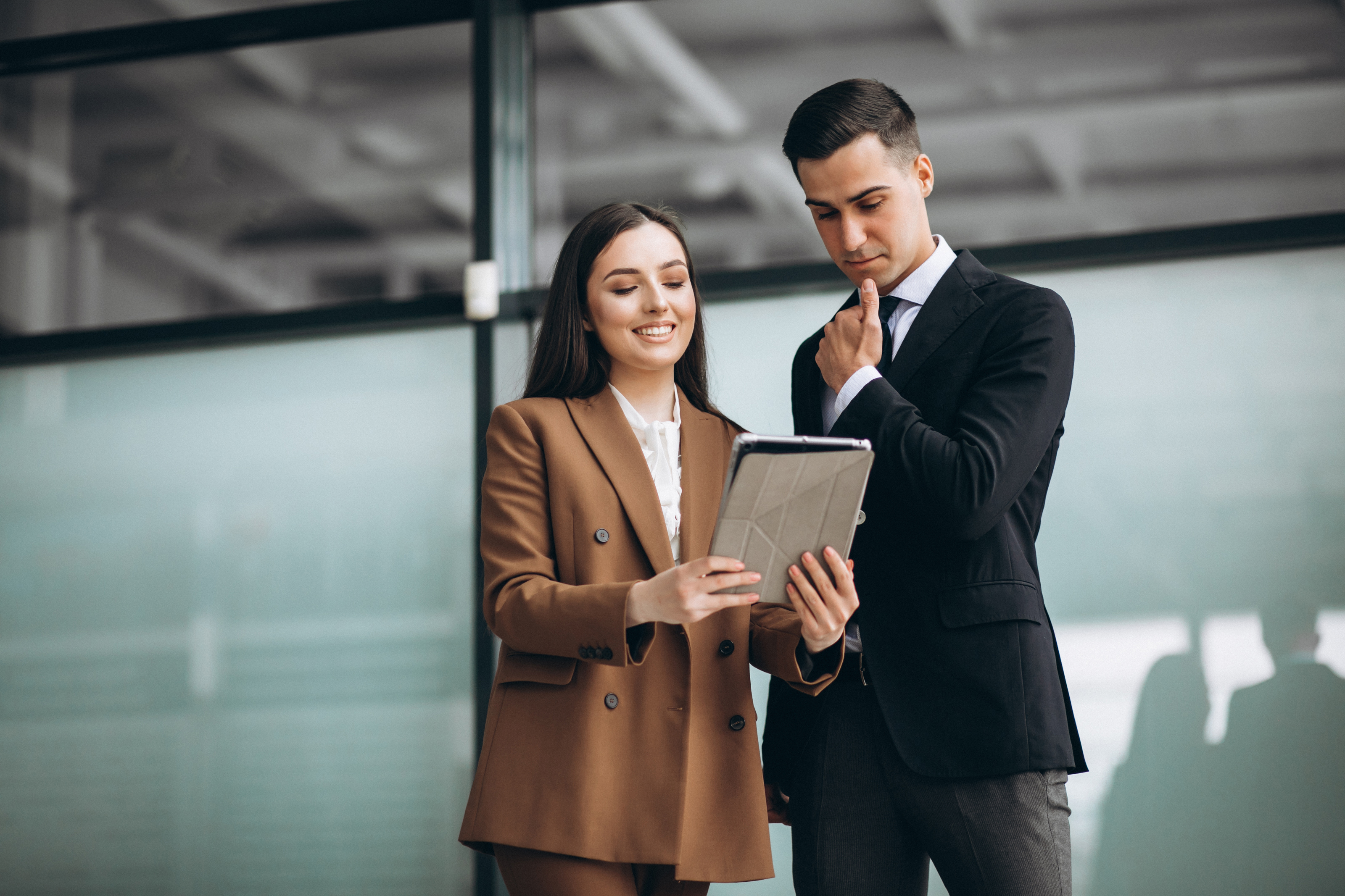 male and female business people working on tablet in office